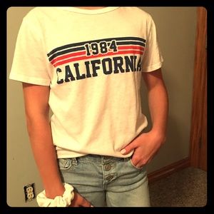 White striped 1984 women’s S tee